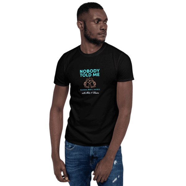 A male model wearing a nobody told me tee