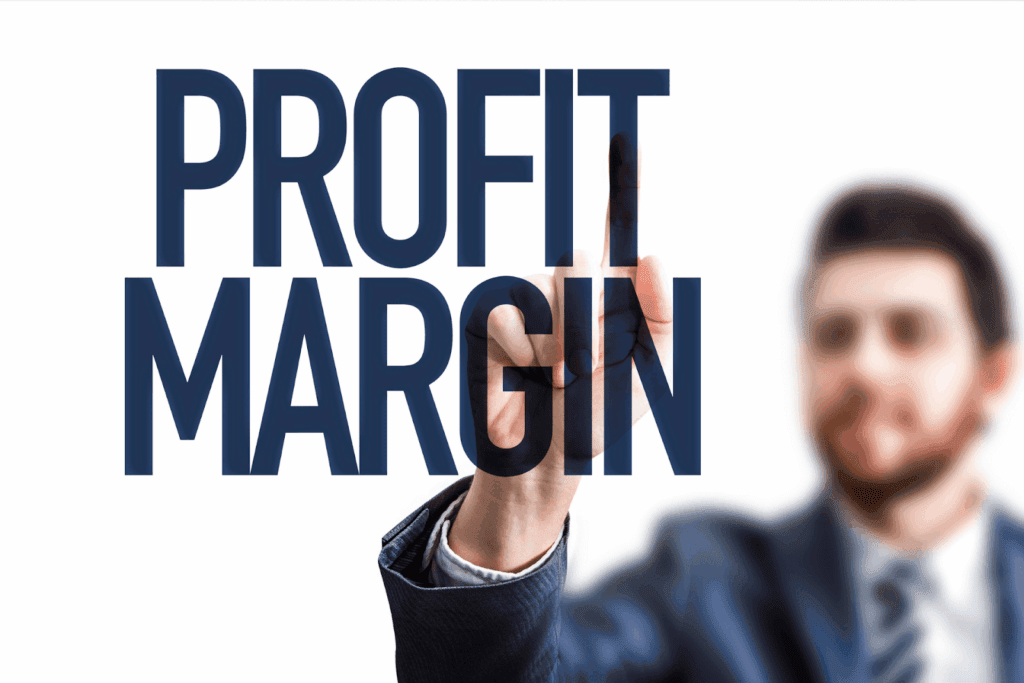 Businessman pointing at Profit Margin text on transparent screen