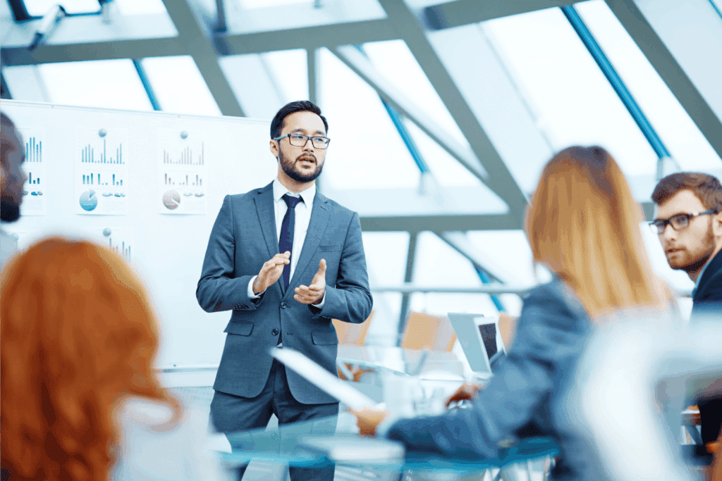 Man presenting financial charts during a business meeting