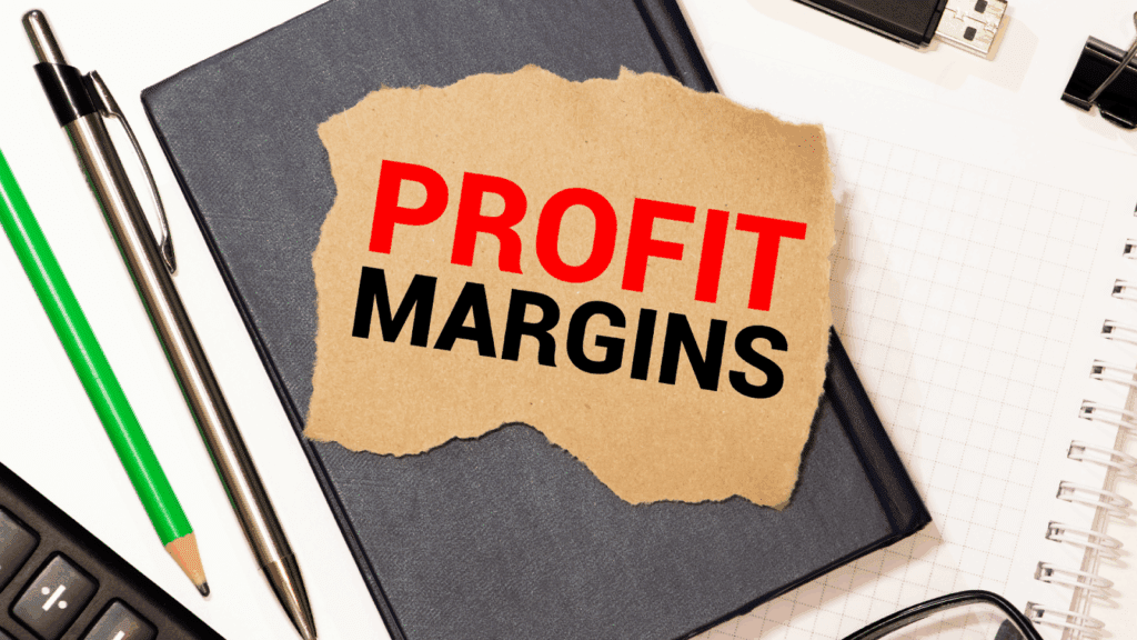 Torn paper with PROFIT MARGINS text on office desk