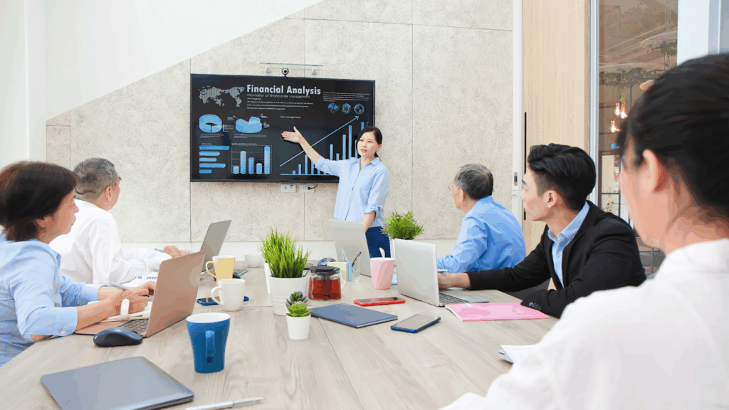 Woman presenting financial analysis to team in meeting