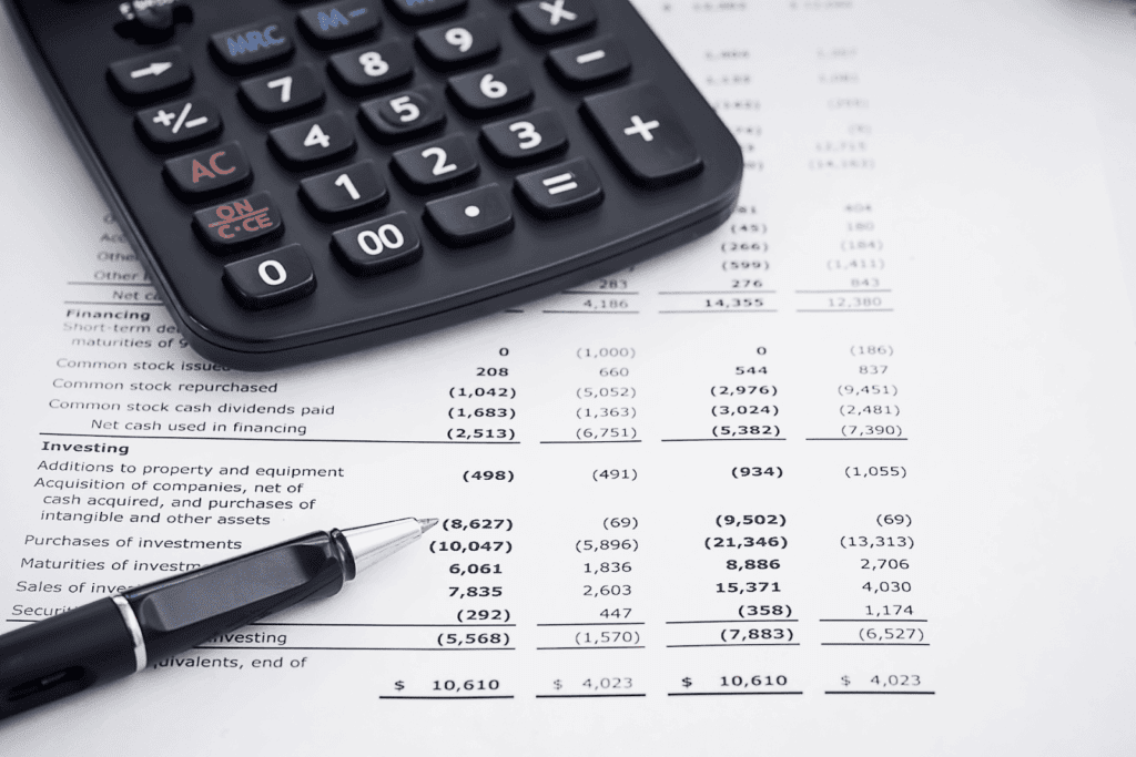 Calculator and pen on a financial statement or report.