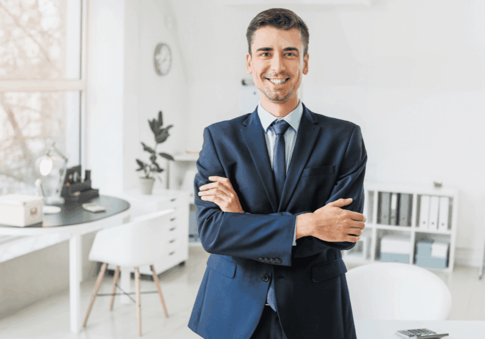 Confident businessman in a suit smiling in a modern office