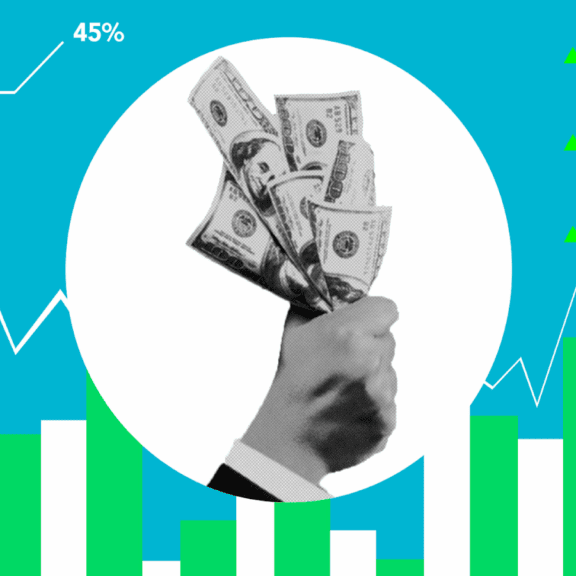 Hand holding money with charts and dollar amounts