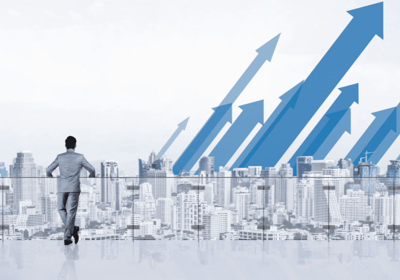 Man overlooking city with upward arrows in the sky