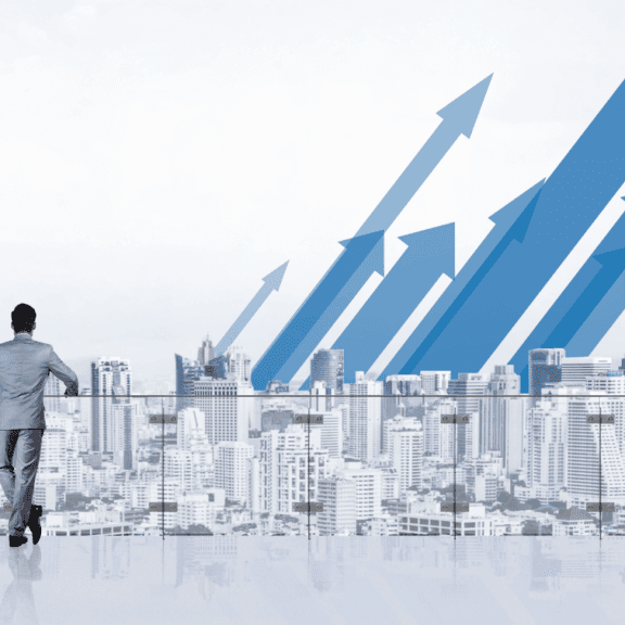 Man overlooking city with upward arrows in the sky