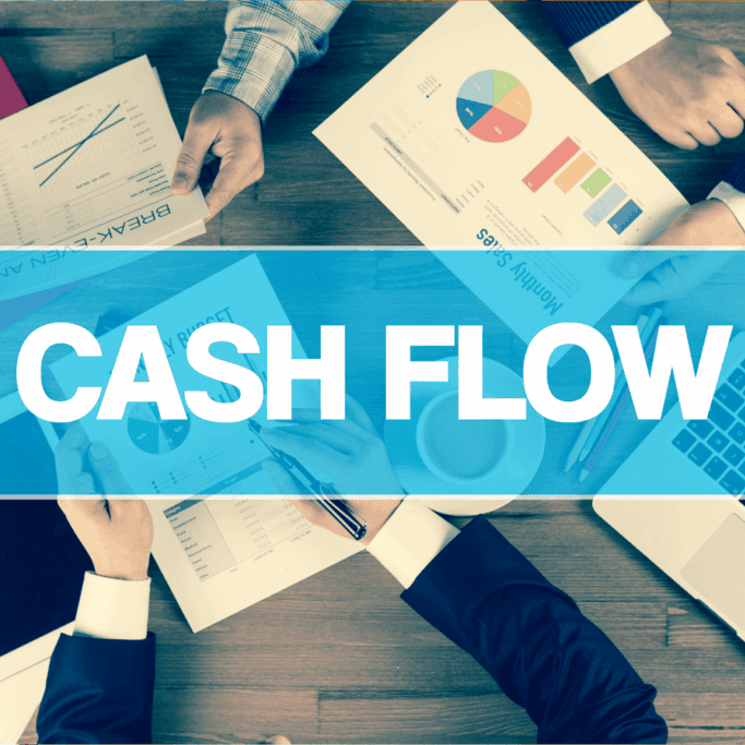 People reviewing financial reports and charts at a table with CASH FLOW highlighted in bold across the image