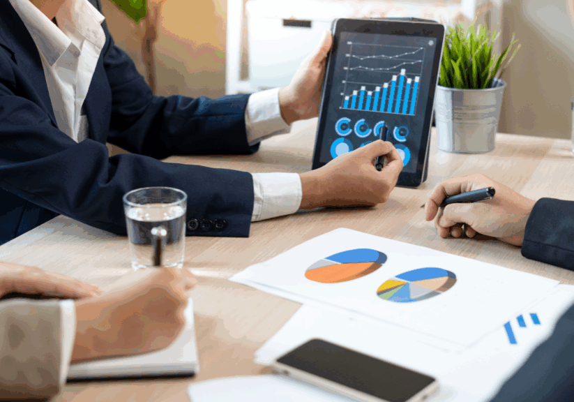Team reviewing tablet with charts during a meeting