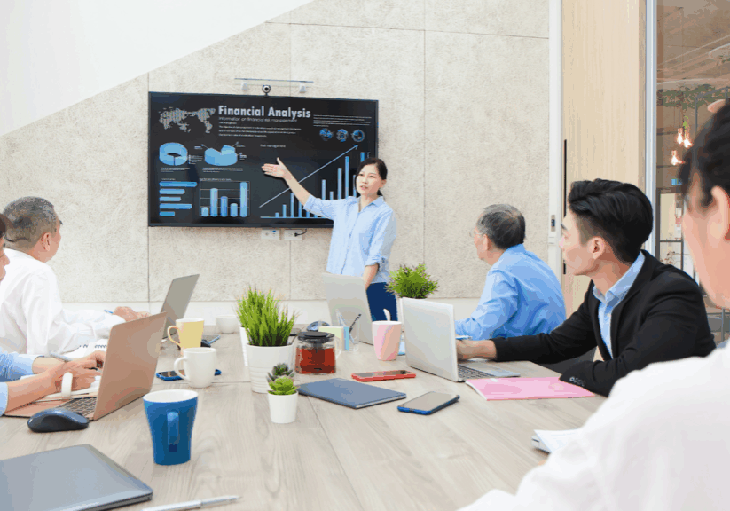 Woman presenting financial analysis to team in meeting